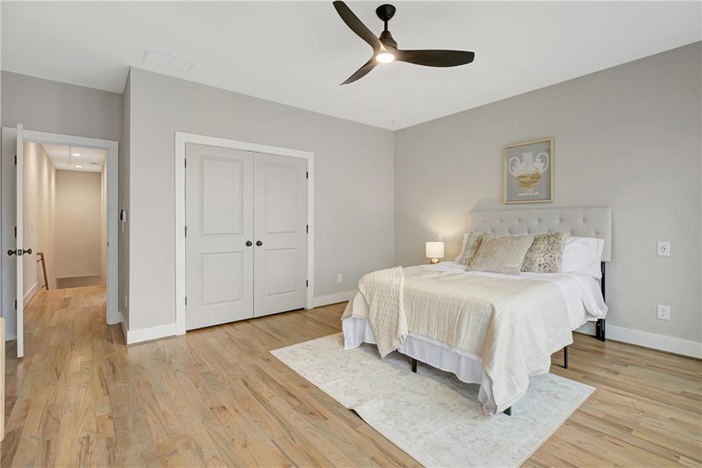454 Connally Street Southeast Atlanta, GA 30312 - Photo 29 of 32 a spacious bedroom with a bed and wooden floor