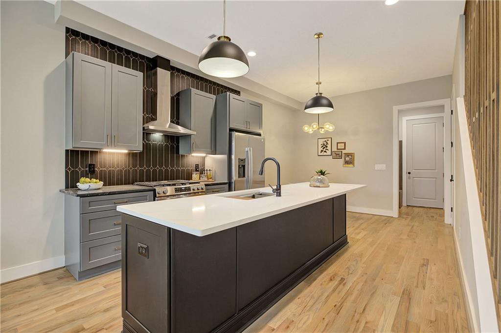 454 Connally Street Southeast Atlanta, GA 30312 - Photo 6 of 32 a kitchen with a sink cabinets and wooden floor