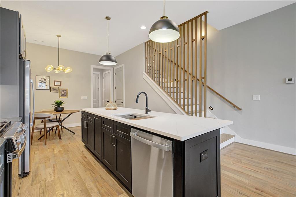 454 Connally Street Southeast Atlanta, GA 30312 - Photo 7 of 32 a kitchen with a sink cabinets and wooden floor