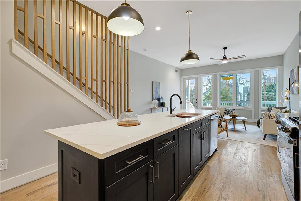 454 Connally Street Southeast Atlanta, GA 30312 - Photo 10 of 32 a kitchen with sink cabinets and wooden floor