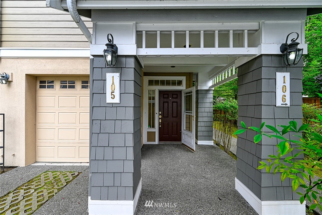 4325 Northeast 5th Court, Unit 105 Renton, WA 98059 - Photo 1 of 1 a front view of a house with a yard