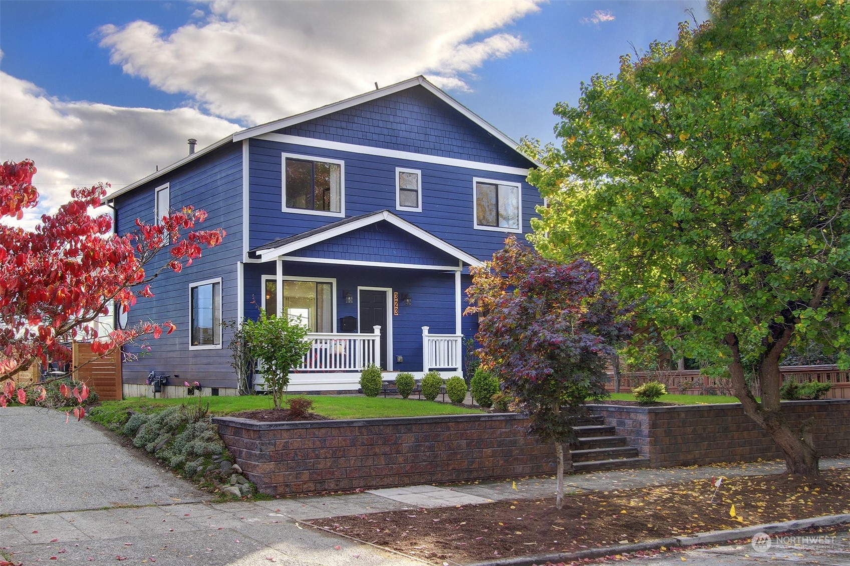 323 Northeast 76th Street Seattle, WA 98115 - Photo 1 of 33 a front view of a house with garden