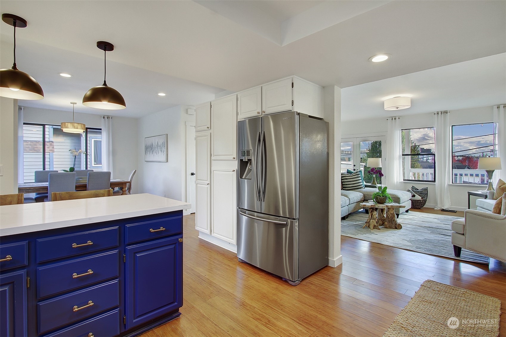 323 Northeast 76th Street Seattle, WA 98115 - Photo 12 of 33 a kitchen with stainless steel appliances a refrigerator and a wooden floors