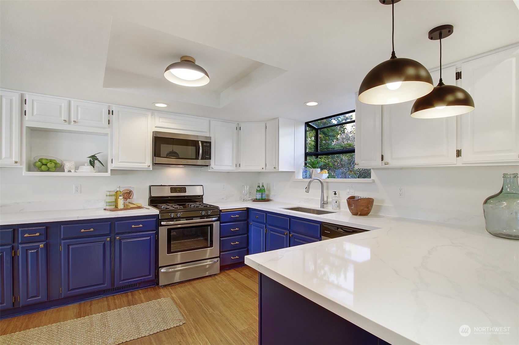 323 Northeast 76th Street Seattle, WA 98115 - Photo 13 of 33 a kitchen with a sink a stove and cabinets