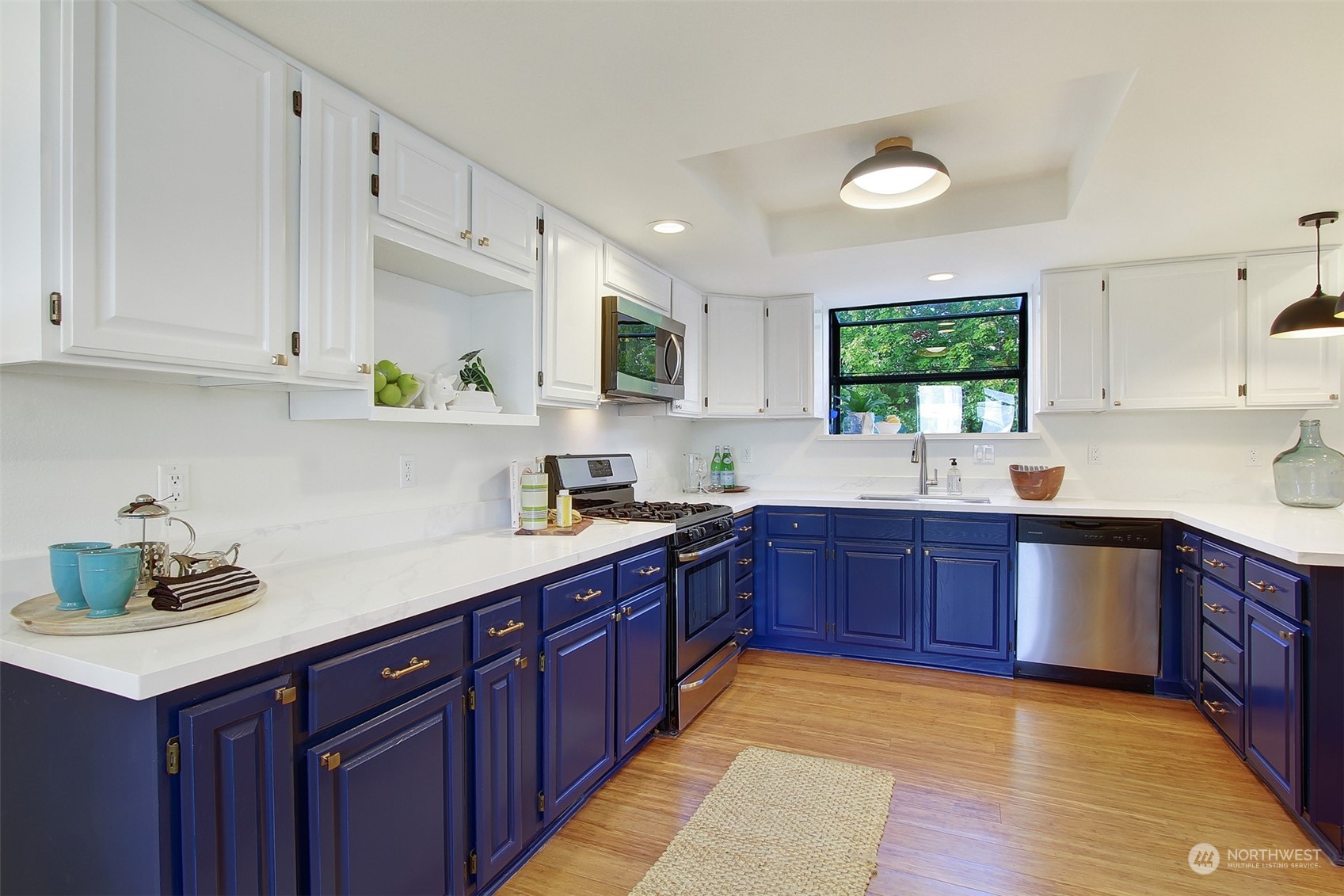 323 Northeast 76th Street Seattle, WA 98115 - Photo 15 of 33 a kitchen with stainless steel appliances granite countertop a sink stove and cabinets