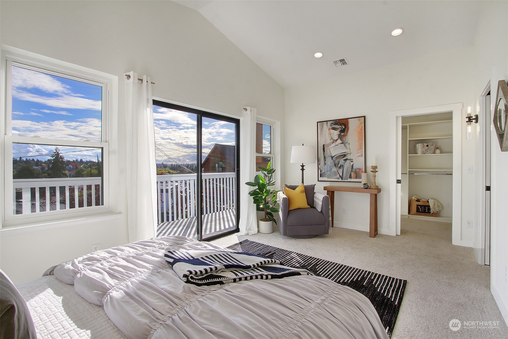 323 Northeast 76th Street Seattle, WA 98115 - Photo 19 of 33 a bedroom with a balcony a bed and a couch