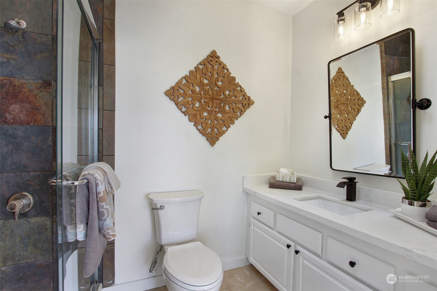 323 Northeast 76th Street Seattle, WA 98115 - Photo 23 of 33 a bathroom with a toilet sink vanity and mirror