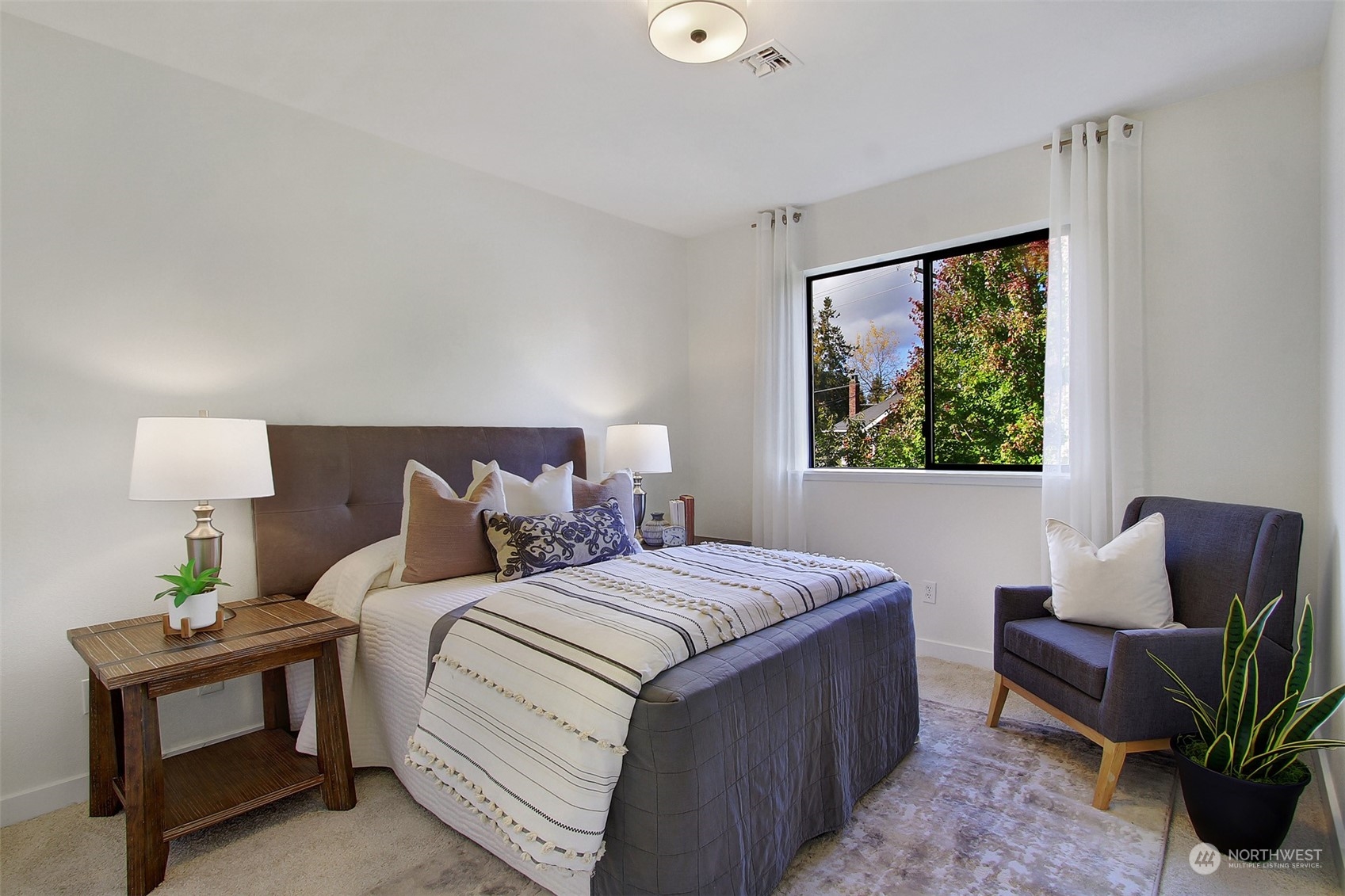 323 Northeast 76th Street Seattle, WA 98115 - Photo 25 of 33 a bedroom with a bed and a window