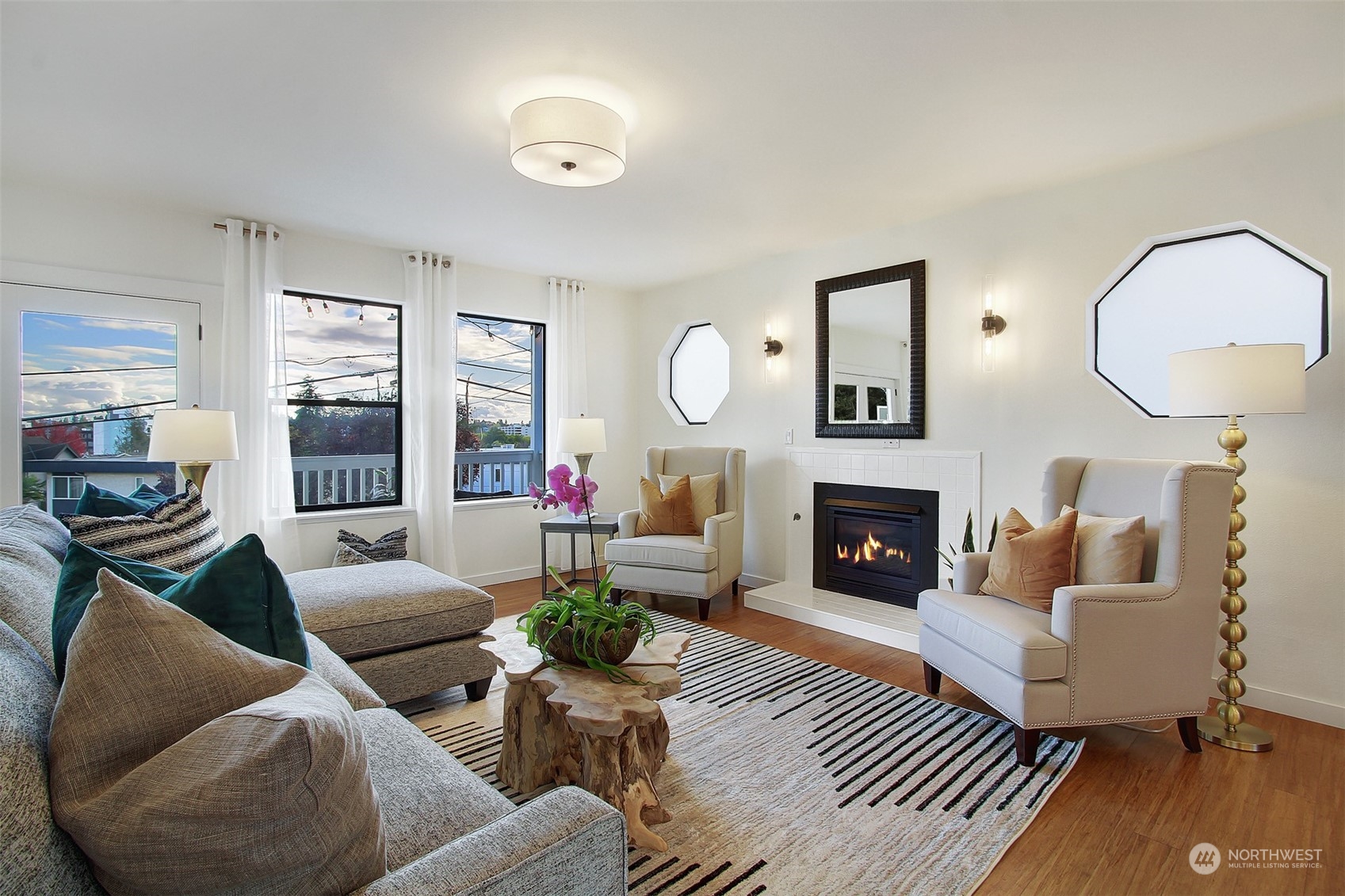 323 Northeast 76th Street Seattle, WA 98115 - Photo 8 of 33 a living room with furniture a fireplace and a large window
