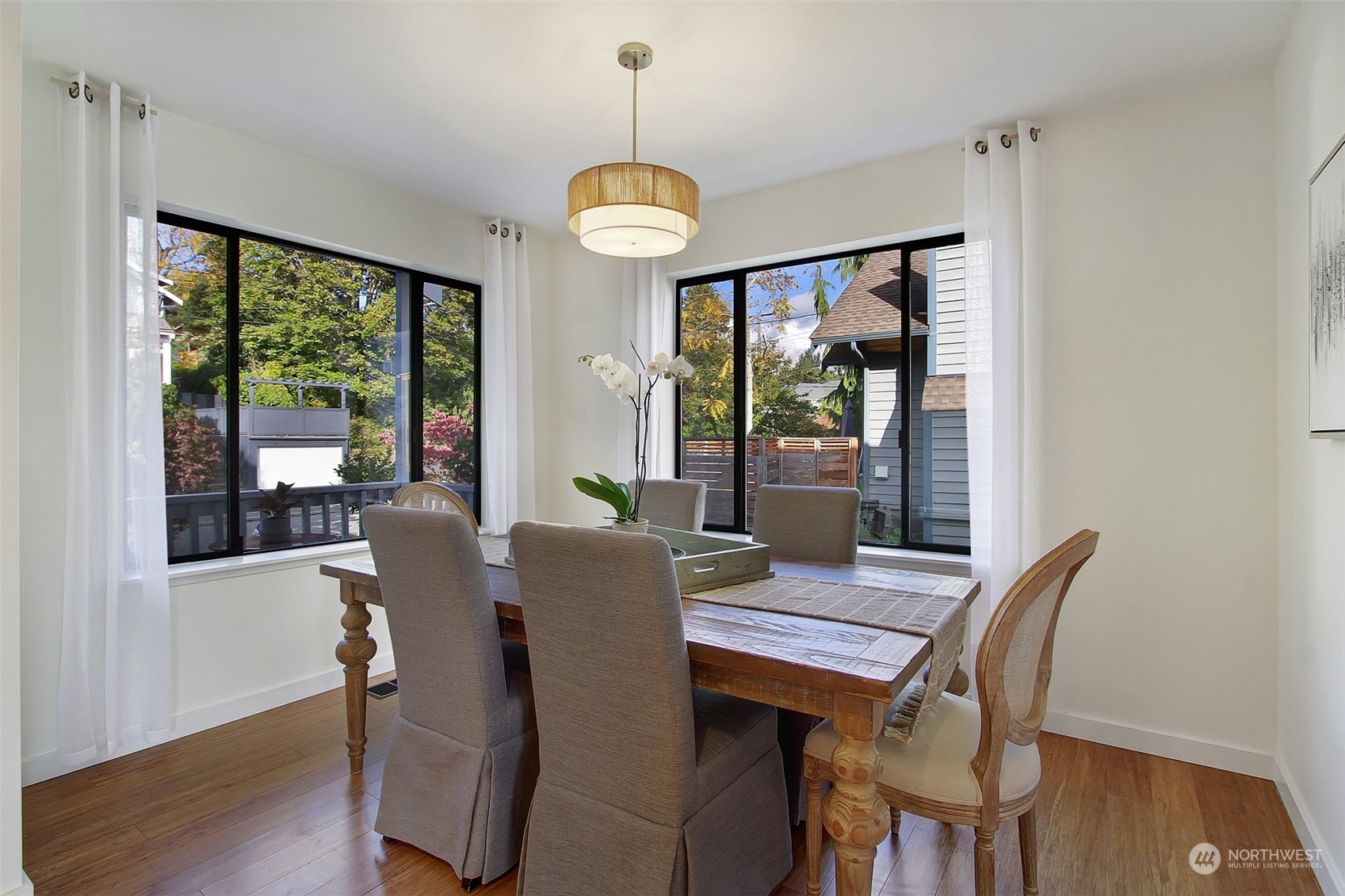 323 Northeast 76th Street Seattle, WA 98115 - Photo 10 of 33 a view of a dining room with furniture window and wooden floor