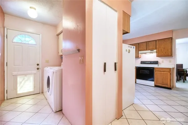 a view of a kitchen cabinets and a refrigerator