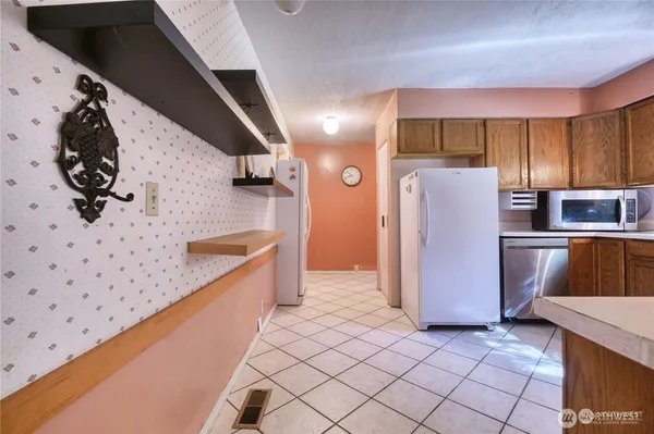 a kitchen with refrigerator and microwave