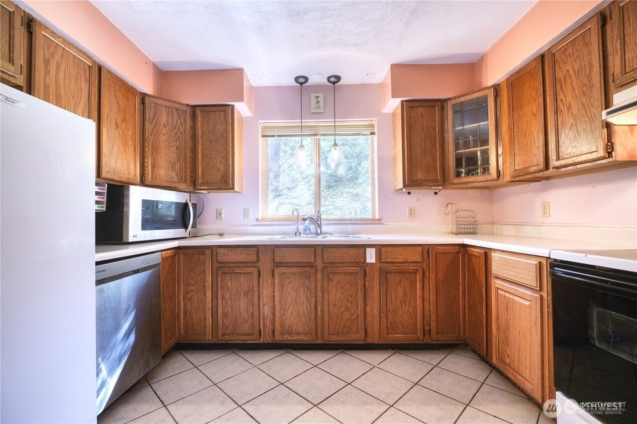 1857 Washington Drive Point Roberts, WA 98281 - Photo 14 of 38 a kitchen with stainless steel appliances granite countertop a sink microwave and window