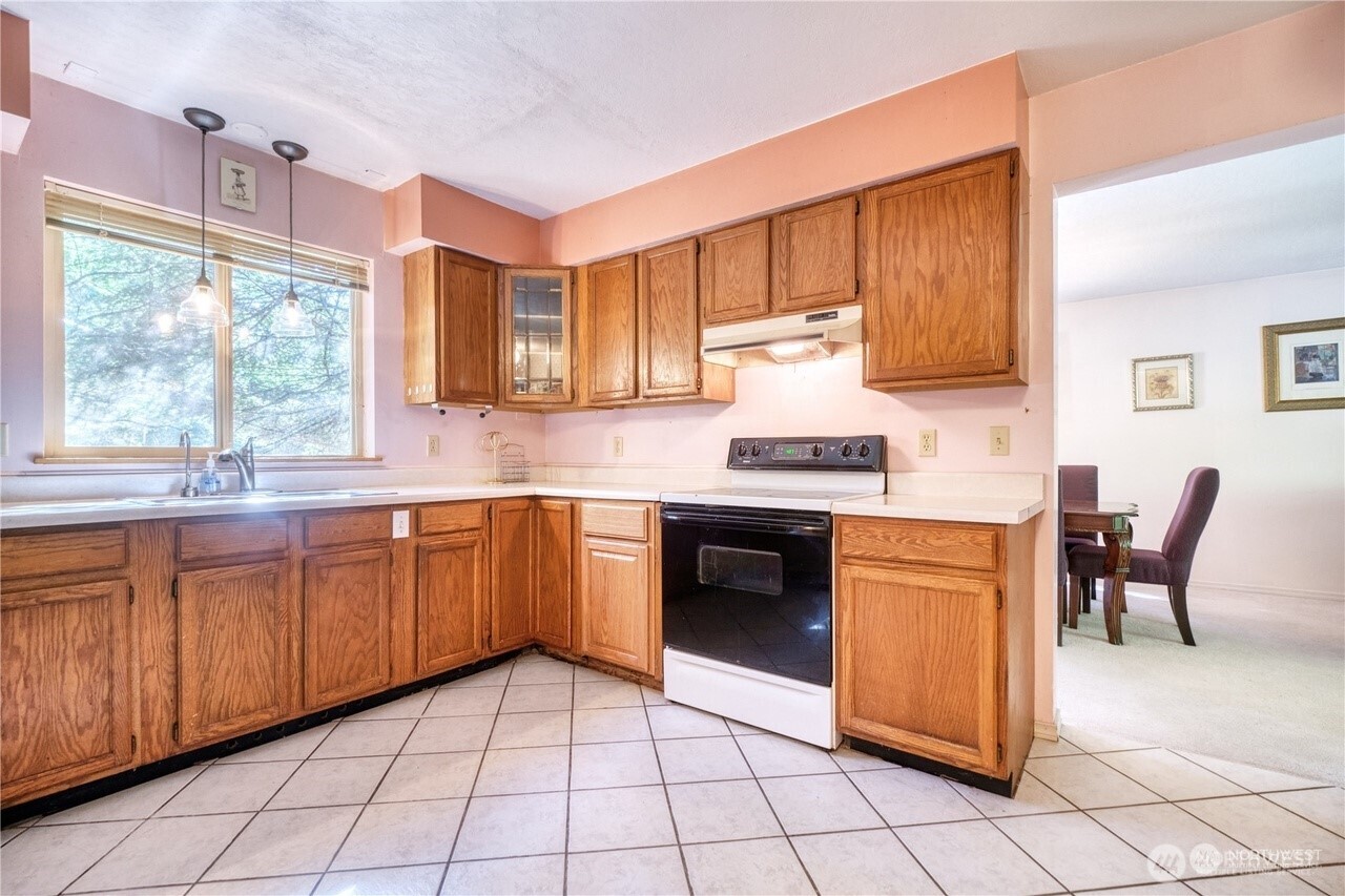 1857 Washington Drive Point Roberts, WA 98281 - Photo 15 of 38 a kitchen with stainless steel appliances granite countertop a stove a sink and a microwave