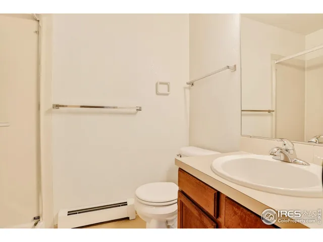 a bathroom with a sink a toilet a shower and a mirror