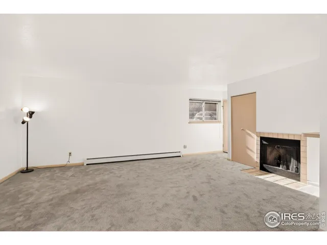 a view of an empty room with a fireplace