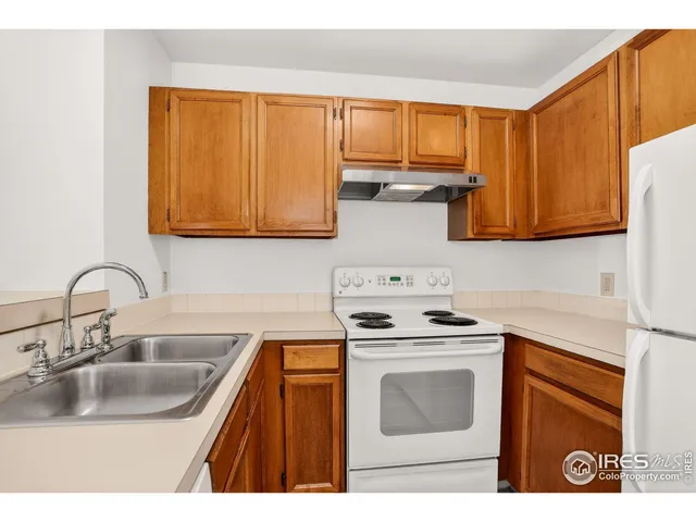 a kitchen with a sink stove top oven and cabinets