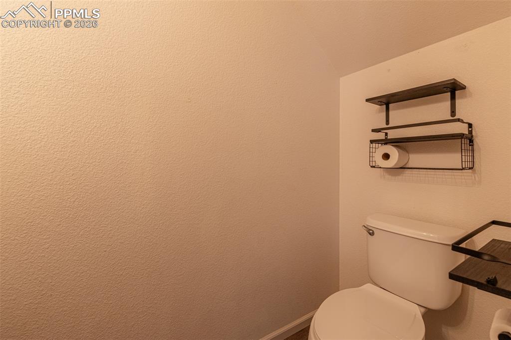 7740 Sandy Springs Point Fountain, CO 80817 - Photo 17 of 34 Bathroom featuring toilet and baseboards