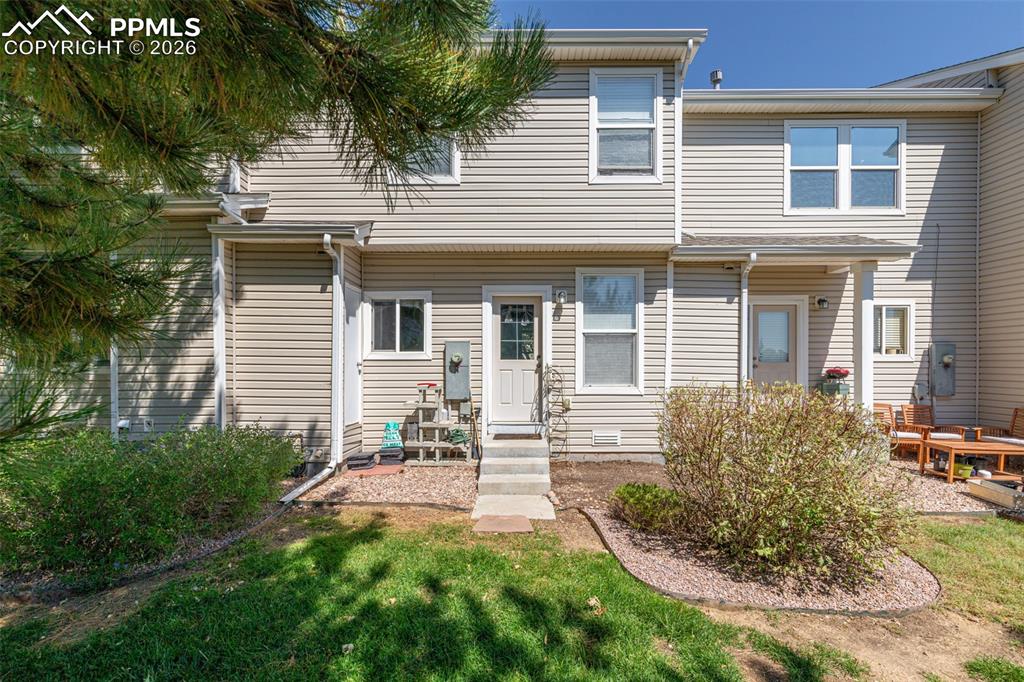 7740 Sandy Springs Point Fountain, CO 80817 - Photo 27 of 34 Rear view of house with a yard