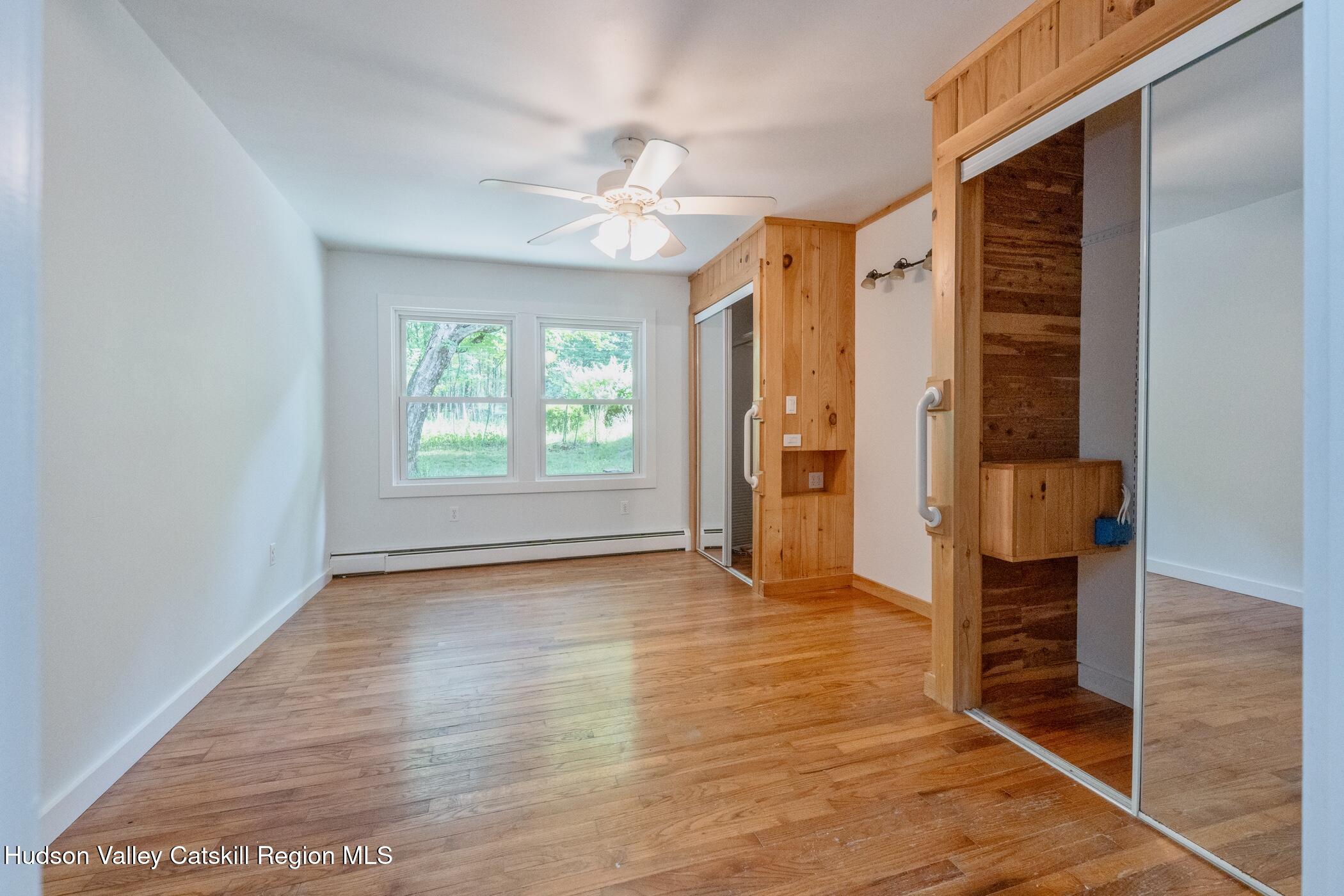 4533 Atwood Road Stone Ridge, NY 12484 - Photo 22 of 63 a view of an empty room with window and wooden floor