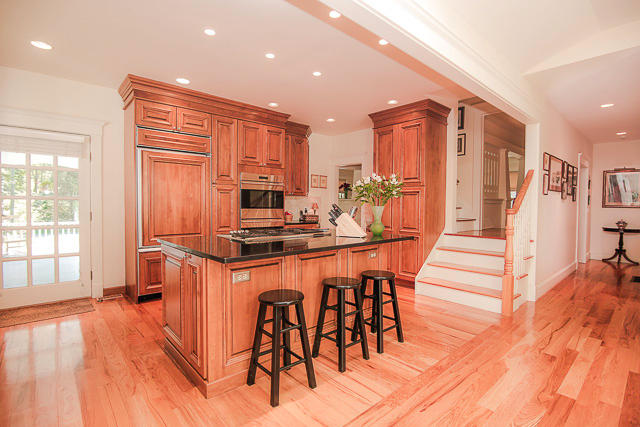 21 Old Studio Road New Canaan, CT 06840 - Photo 13 of 39 a kitchen with stainless steel appliances kitchen island granite countertop a table chairs and a refrigerator