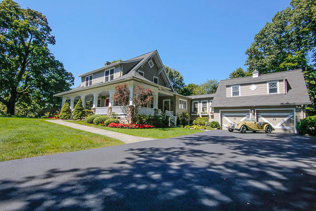 21 Old Studio Road New Canaan, CT 06840 - Photo 23 of 39 a front view of a house with a yard and porch