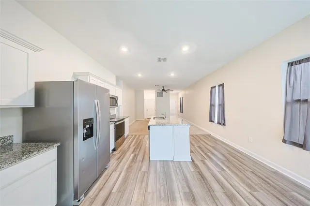 a kitchen with a refrigerator and a sink