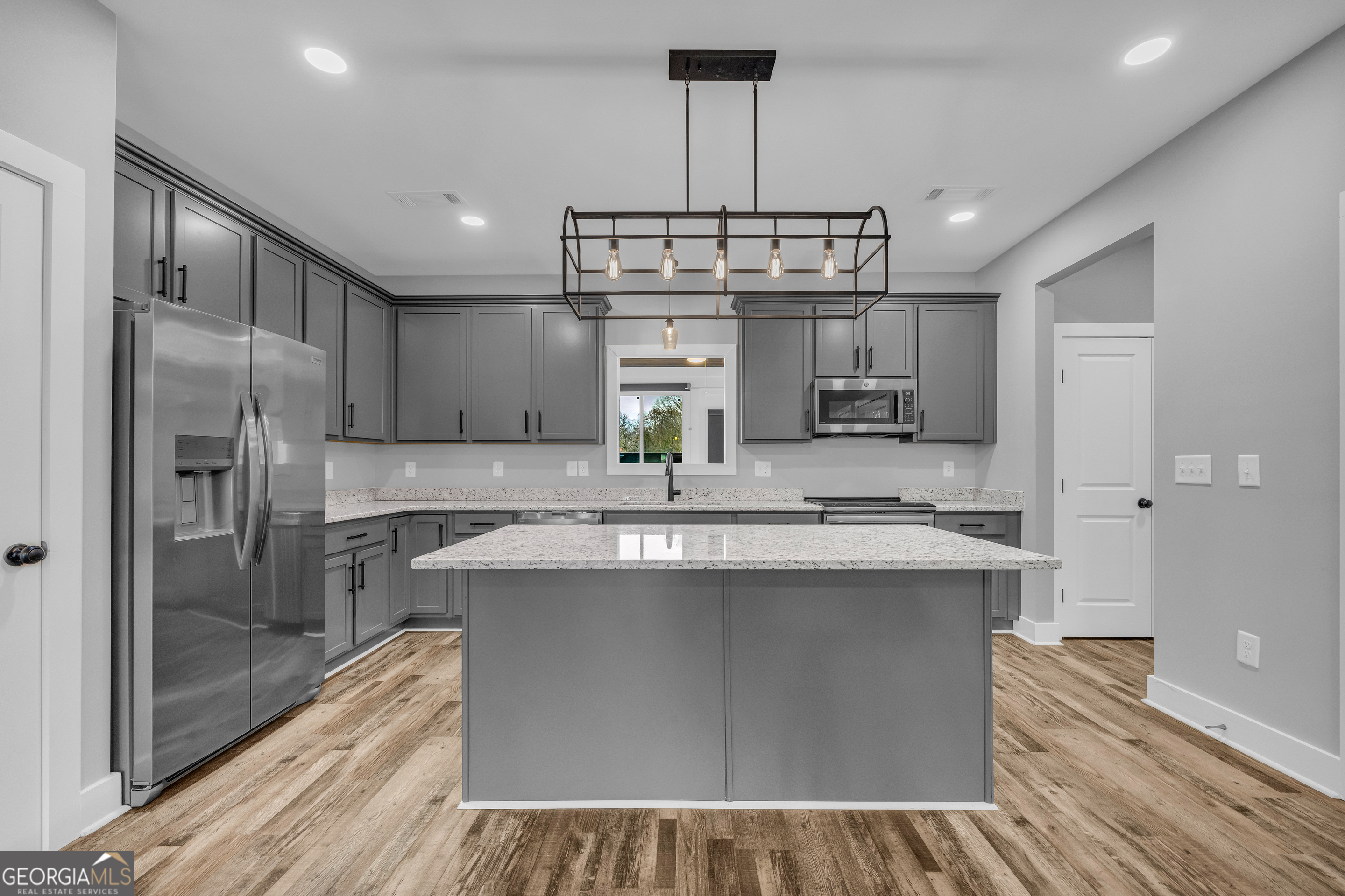 5177 Sandy Cross Road Carnesville, GA 30521 - Photo 36 of 86 a kitchen with kitchen island stainless steel appliances a sink stove and refrigerator