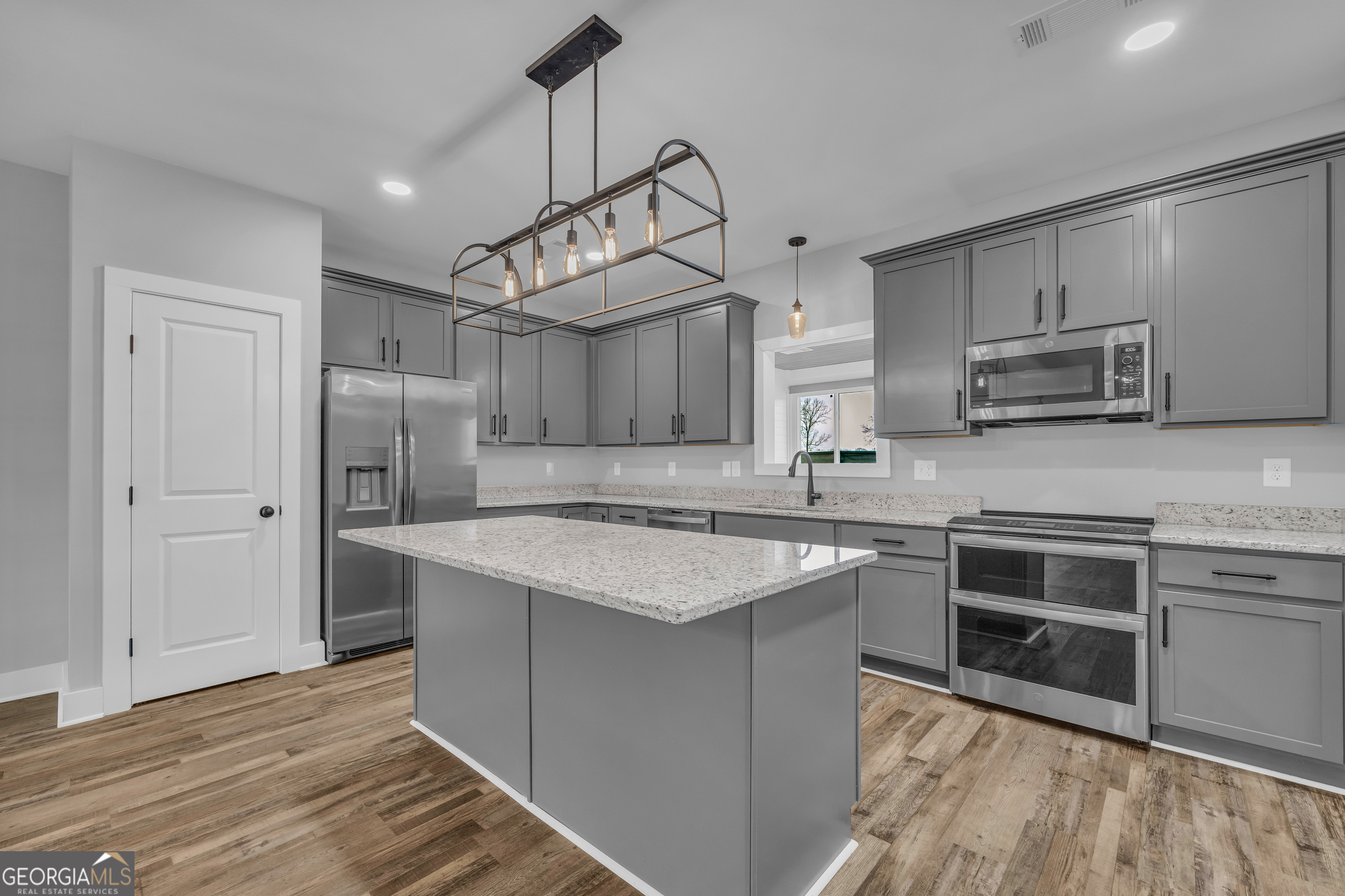 5177 Sandy Cross Road Carnesville, GA 30521 - Photo 37 of 86 a kitchen with stainless steel appliances granite countertop a sink stove and refrigerator