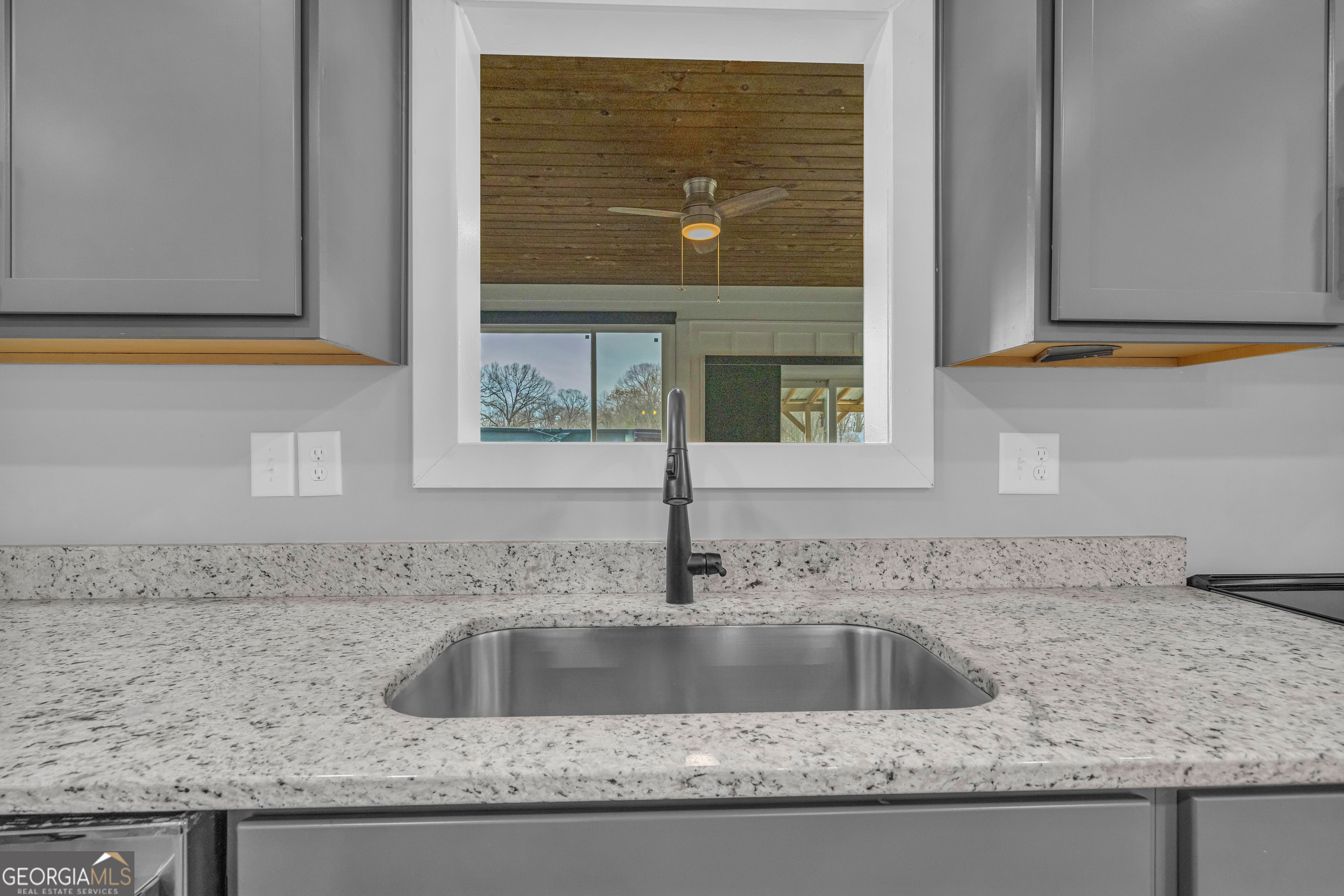 5177 Sandy Cross Road Carnesville, GA 30521 - Photo 42 of 86 a kitchen with granite countertop a sink and a window