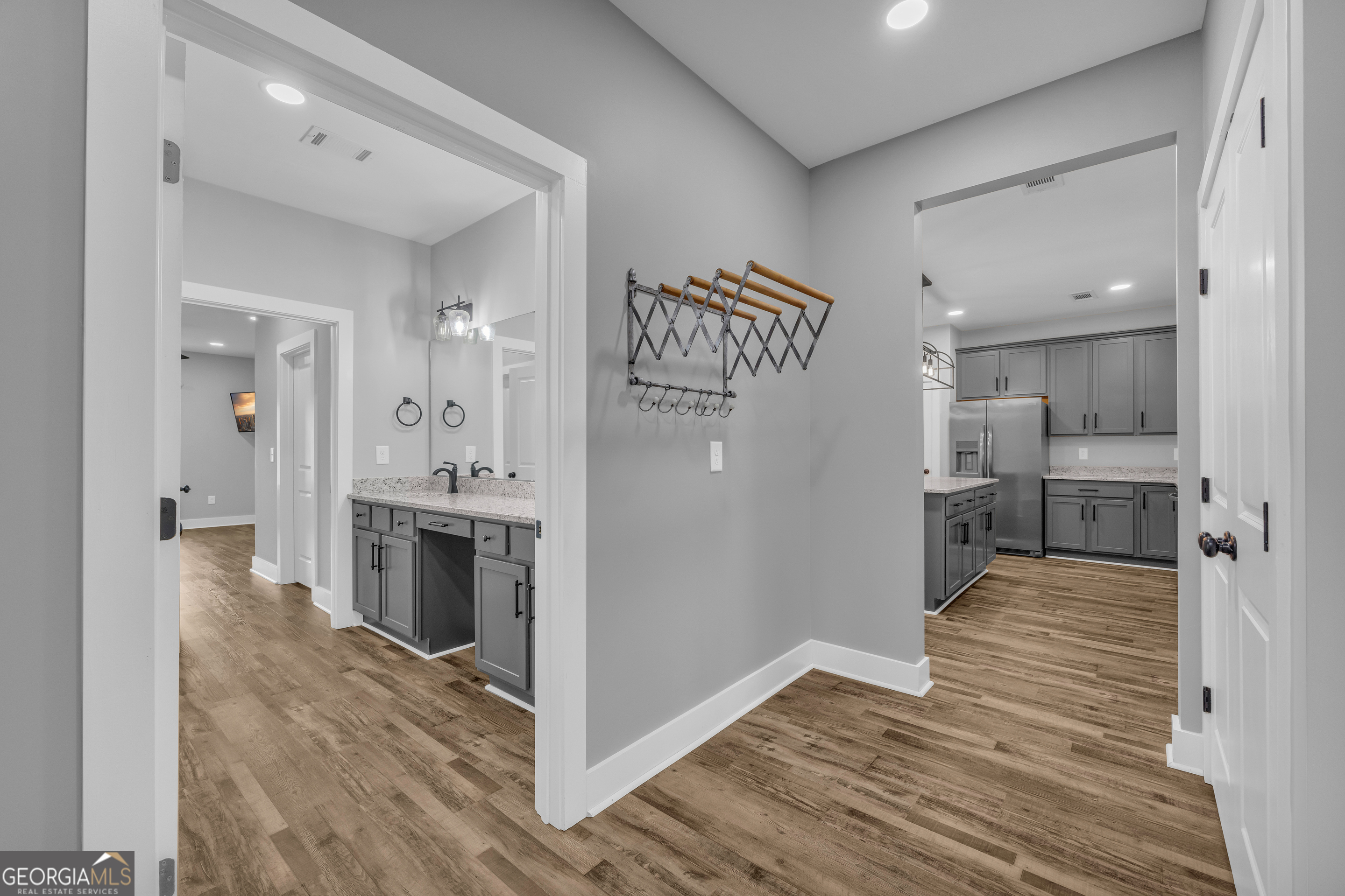 5177 Sandy Cross Road Carnesville, GA 30521 - Photo 48 of 86 a view of a kitchen from the hallway with a sink and wooden floor