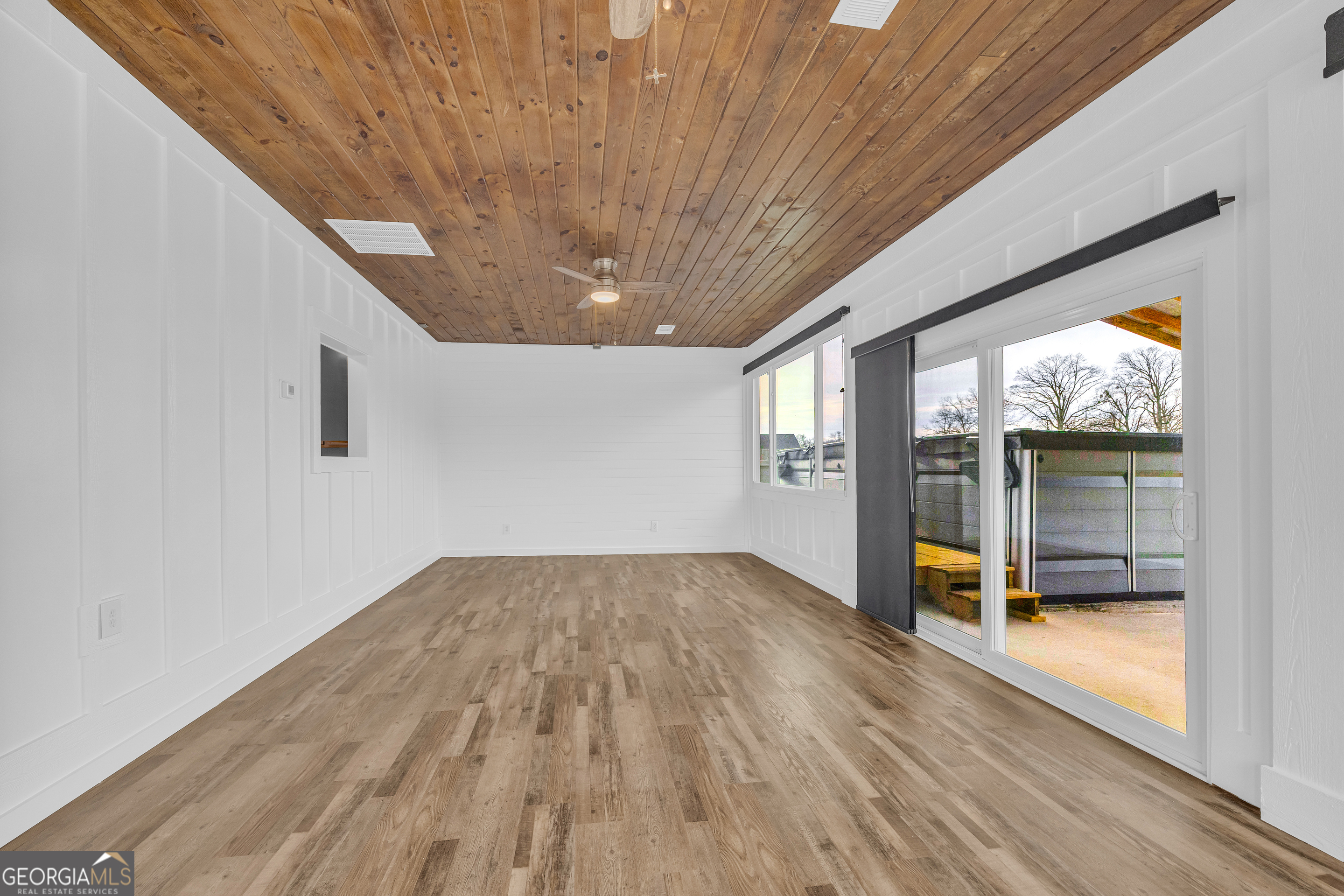 5177 Sandy Cross Road Carnesville, GA 30521 - Photo 50 of 86 a view of empty room with wooden floor and fan