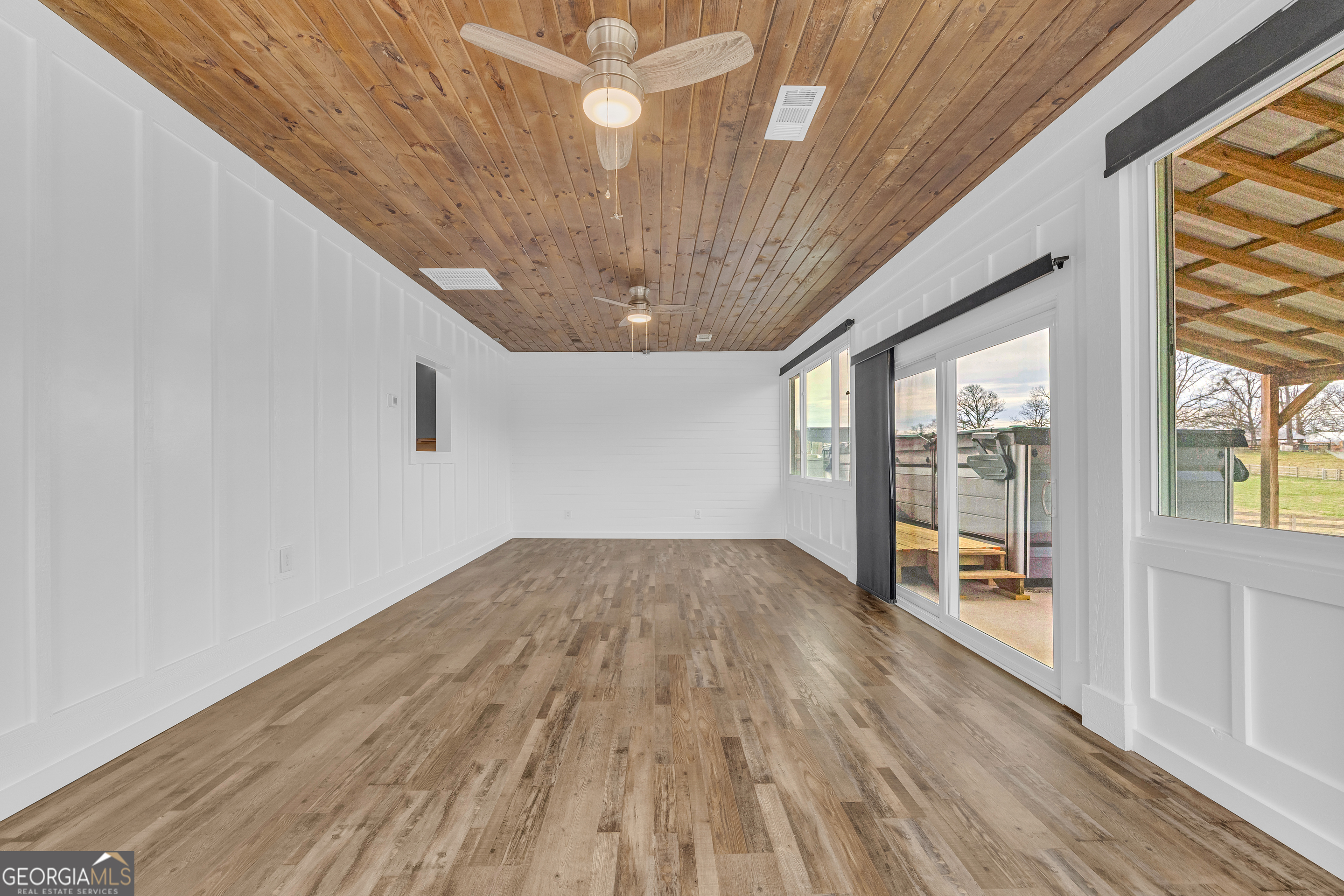 5177 Sandy Cross Road Carnesville, GA 30521 - Photo 54 of 86 a view of empty room with wooden floor and fan