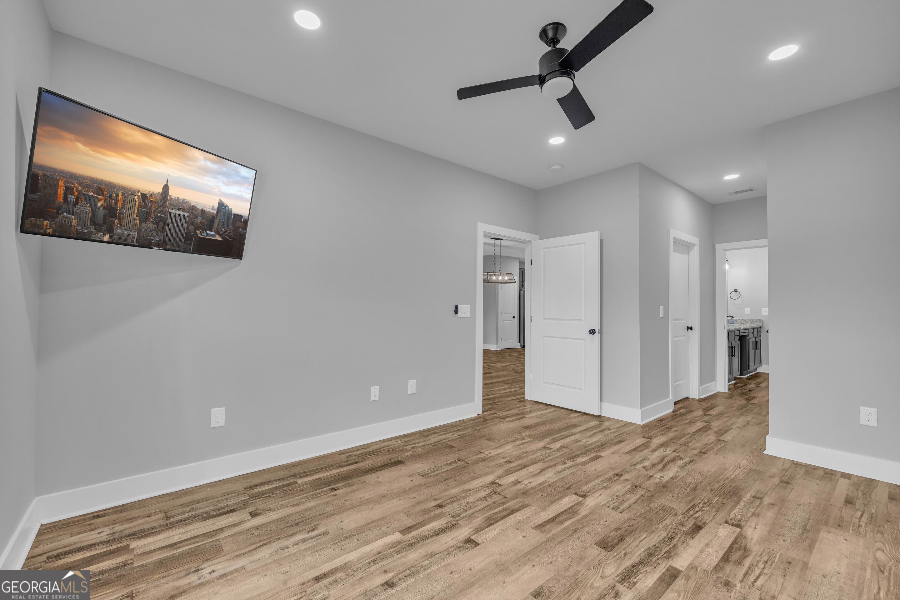 5177 Sandy Cross Road Carnesville, GA 30521 - Photo 60 of 86 a view of empty room with wooden floor and fan