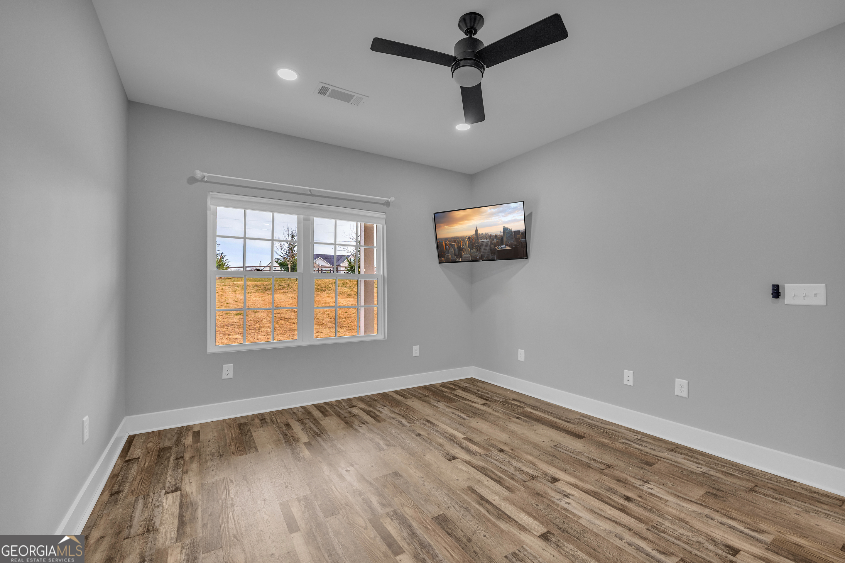 5177 Sandy Cross Road Carnesville, GA 30521 - Photo 61 of 86 a view of empty room with wooden floor and fan
