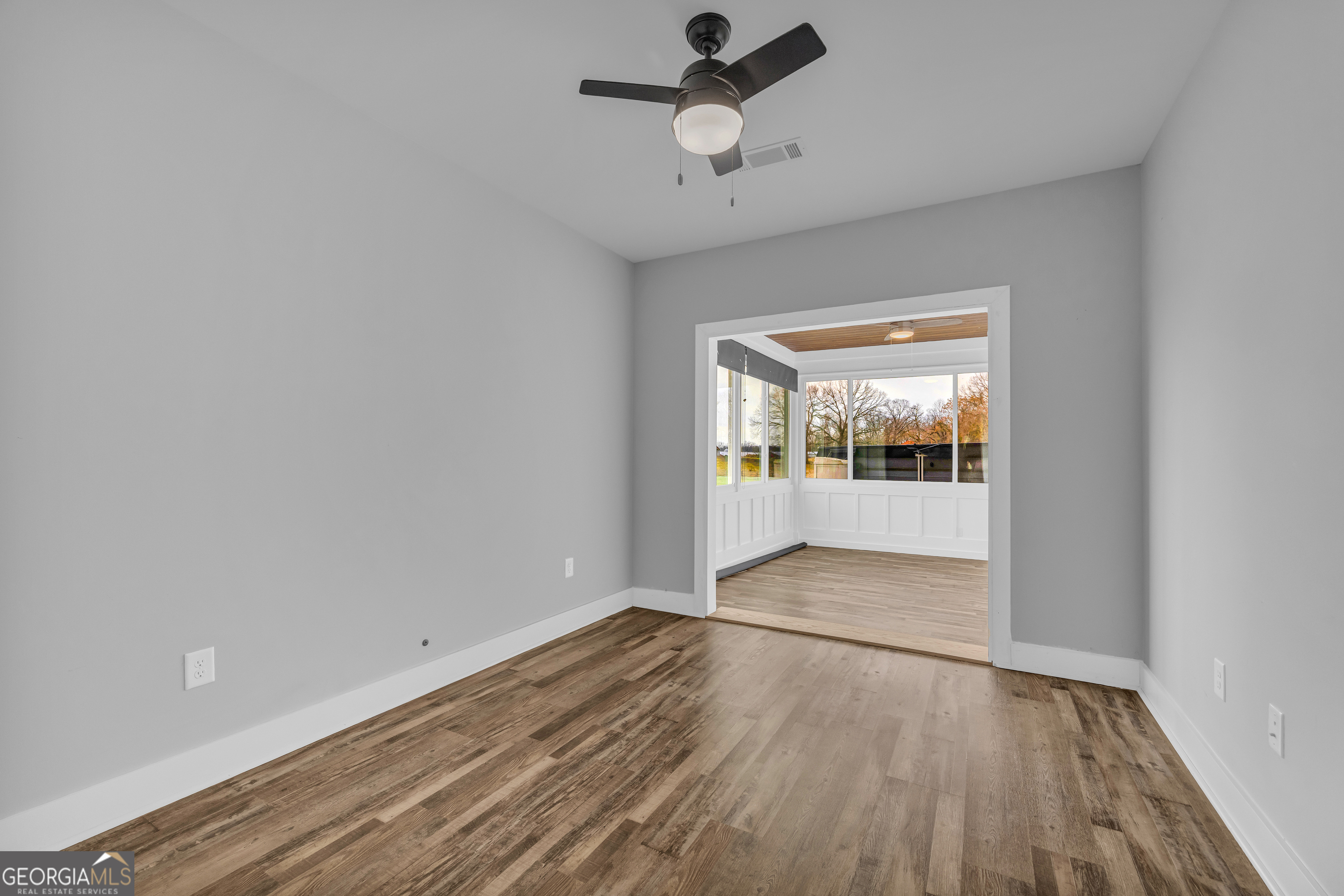 5177 Sandy Cross Road Carnesville, GA 30521 - Photo 75 of 86 a view of an empty room with wooden floor and a window
