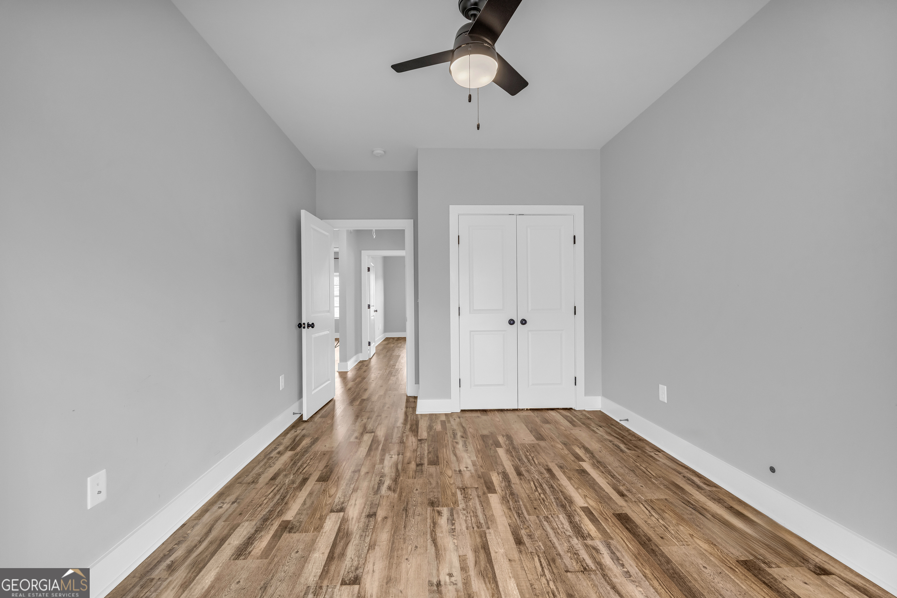5177 Sandy Cross Road Carnesville, GA 30521 - Photo 78 of 86 a view of empty room with wooden floor and fan