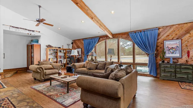 a living room with furniture or couch and a large window
