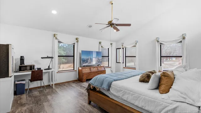 a bedroom with furniture and a wooden floor