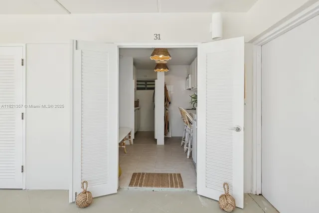 a view of a hallway with closet and a living room