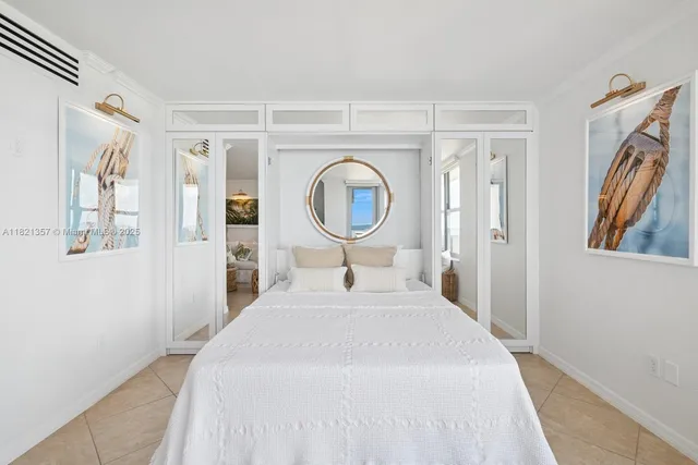 a bedroom with a bed and a mirror