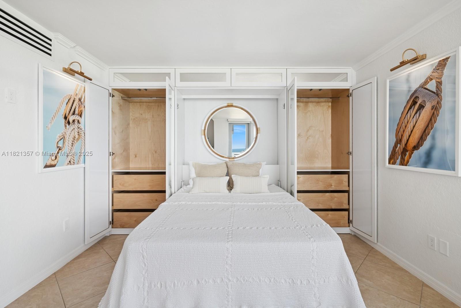 2899 Collins Avenue, Unit 1025 Miami Beach, FL 33140 - Photo 4 of 19 a bedroom with a bed and a large mirror