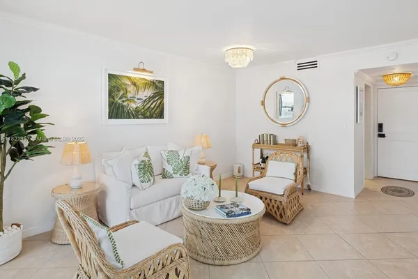 a living room with furniture a rug and a potted plant