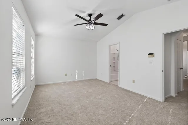 a view of a livingroom with a ceiling fan and window