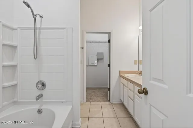 a bathroom with a bathtub and shower