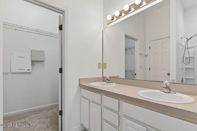 a bathroom with a double vanity sink and a mirror