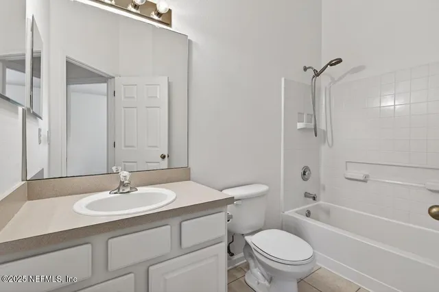 a bathroom with a sink toilet tub vanity and shower