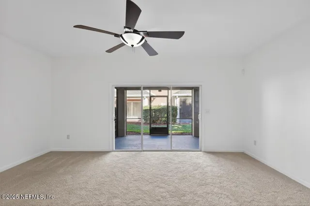 a view of empty room with ceiling fan