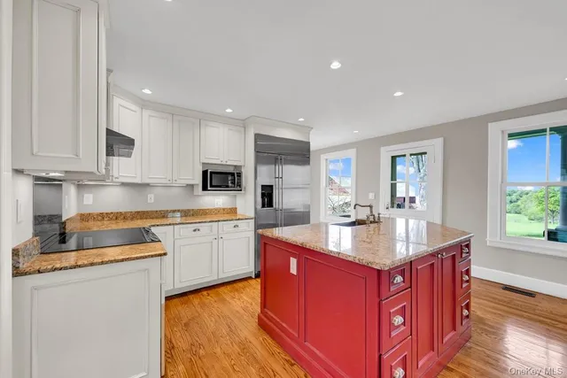 a kitchen with sink stove top oven and microwave