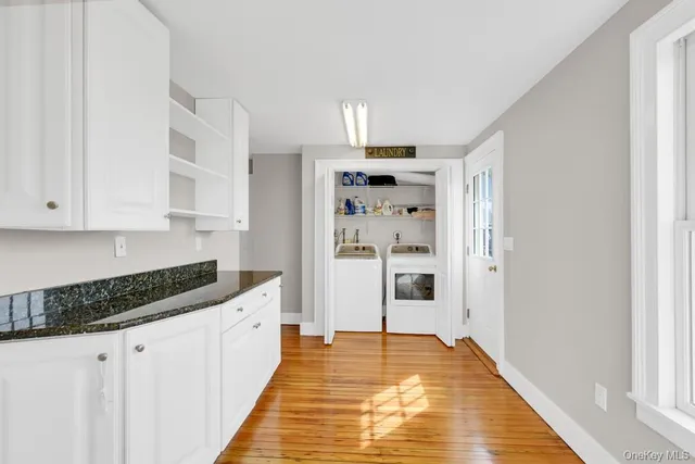 a kitchen with granite countertop a refrigerator and a sink